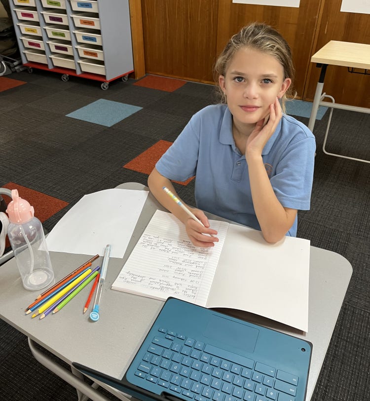 Student writing and working at her desk